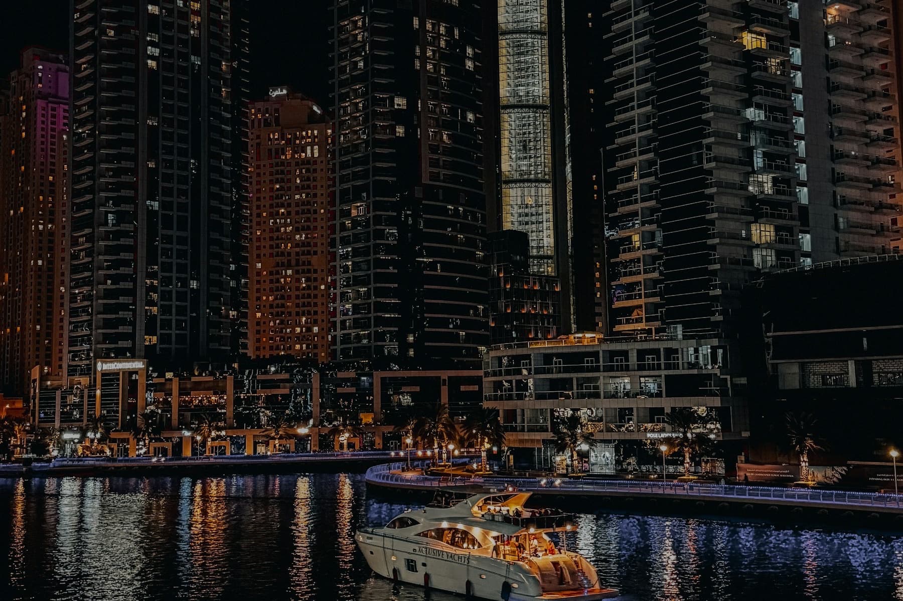 Dubai Marina towers at night reflected in the water